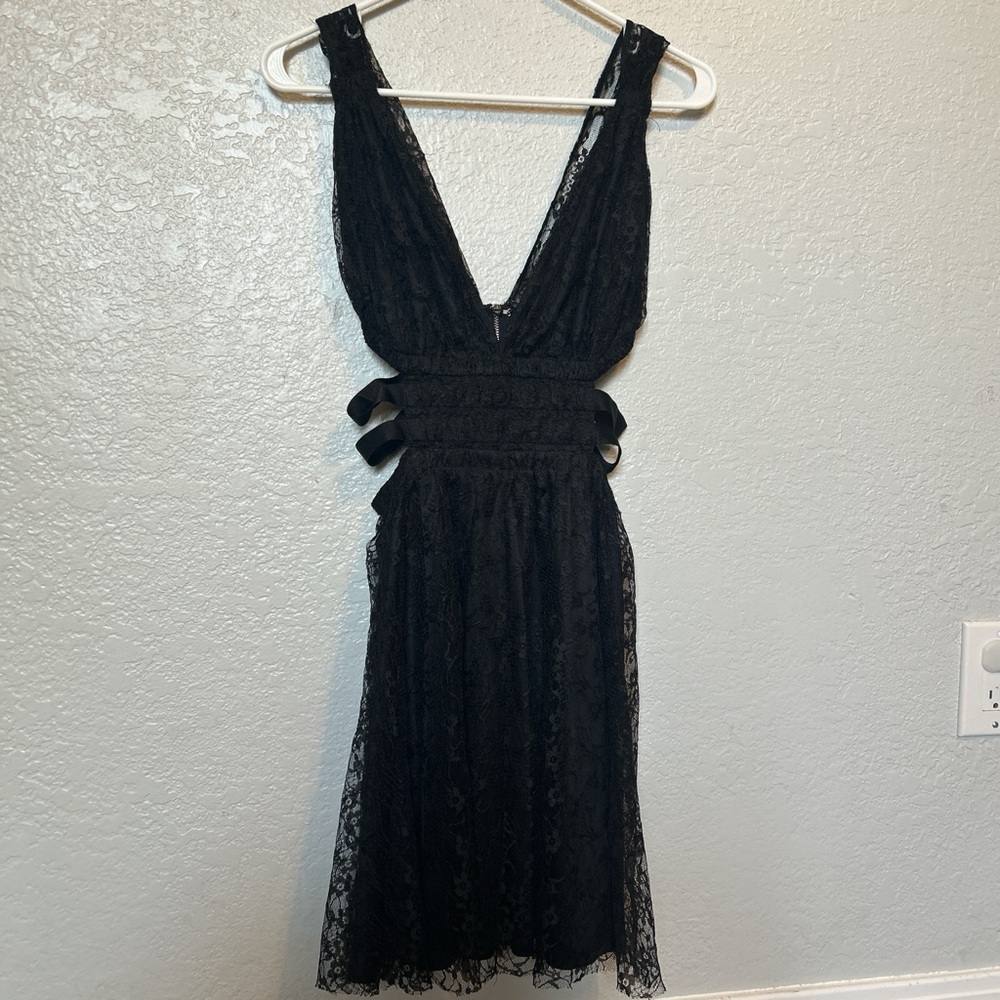 Small women’s laced black dress with exposed sides